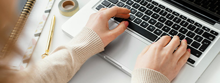 Woman's hands on keyboard of laptop.